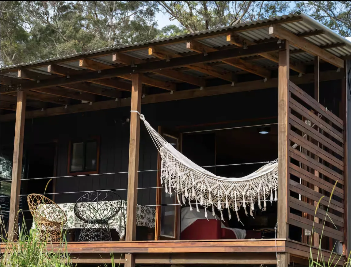 The covered deck with a macramé hammock